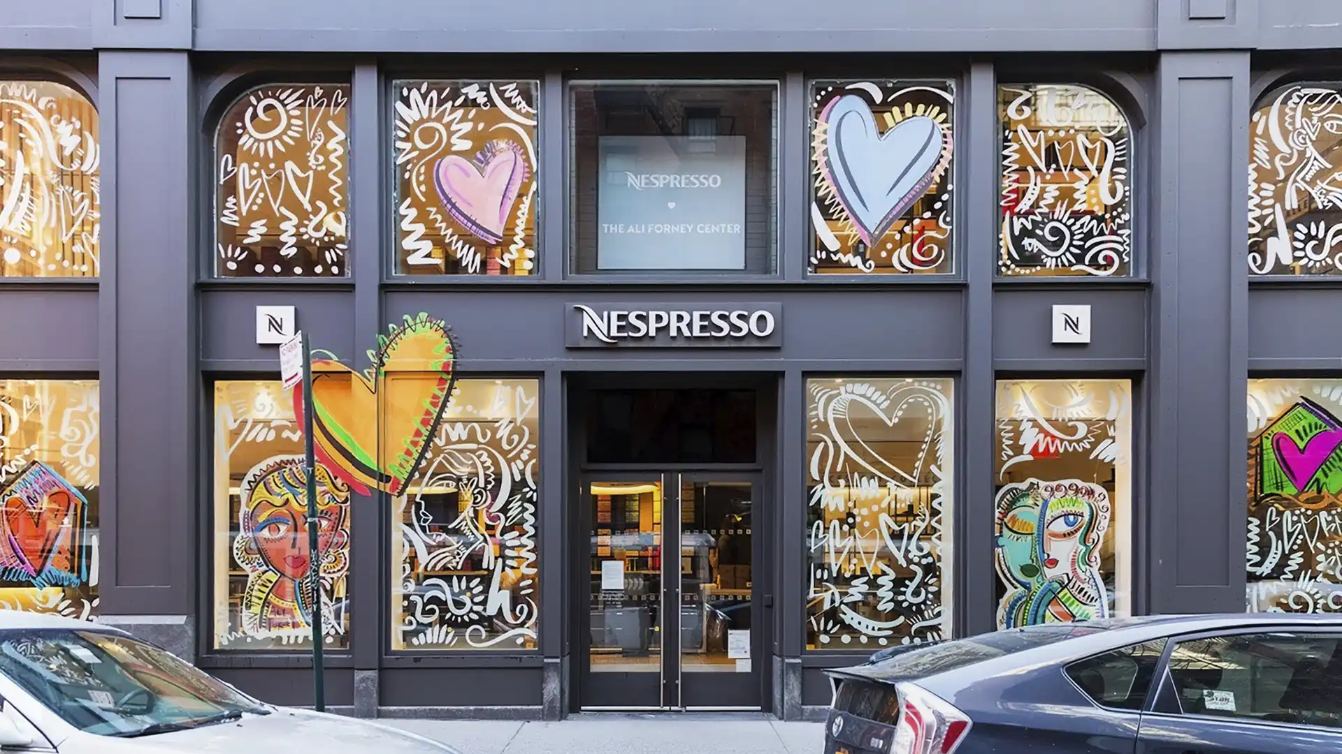 Nespresso boutique at The Ali Forney Center with heart-and-face window art from Things We Hold