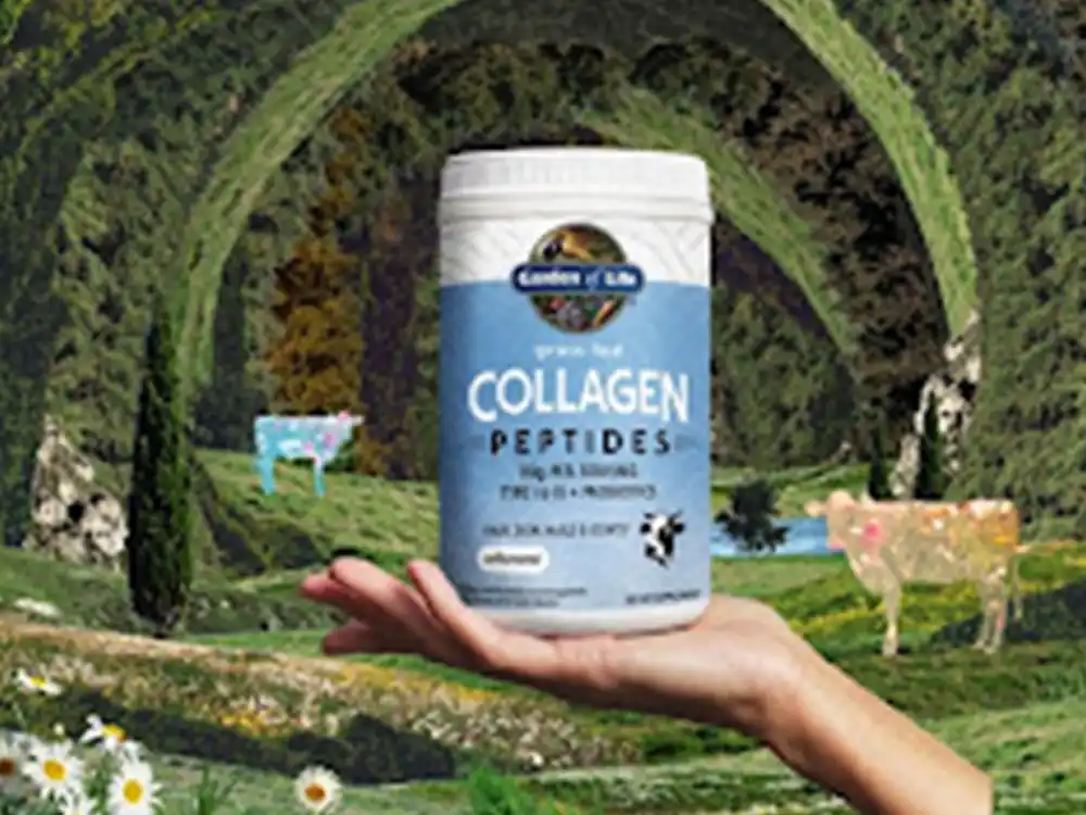 A hand holds Garden of Life Collagen Peptides over a pastoral landscape with cows, from Formulas for Feeling Alive