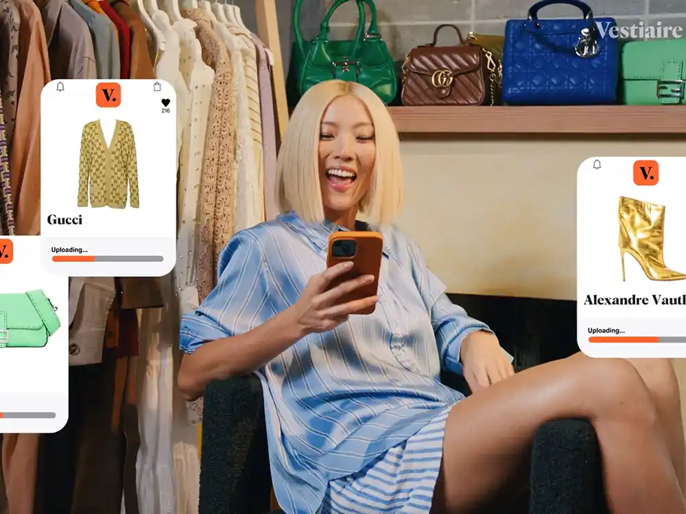 Woman laughs at her phone as Vestiaire listing cards overlay the frame, from Vestiaire Collective's Parlez-vous?