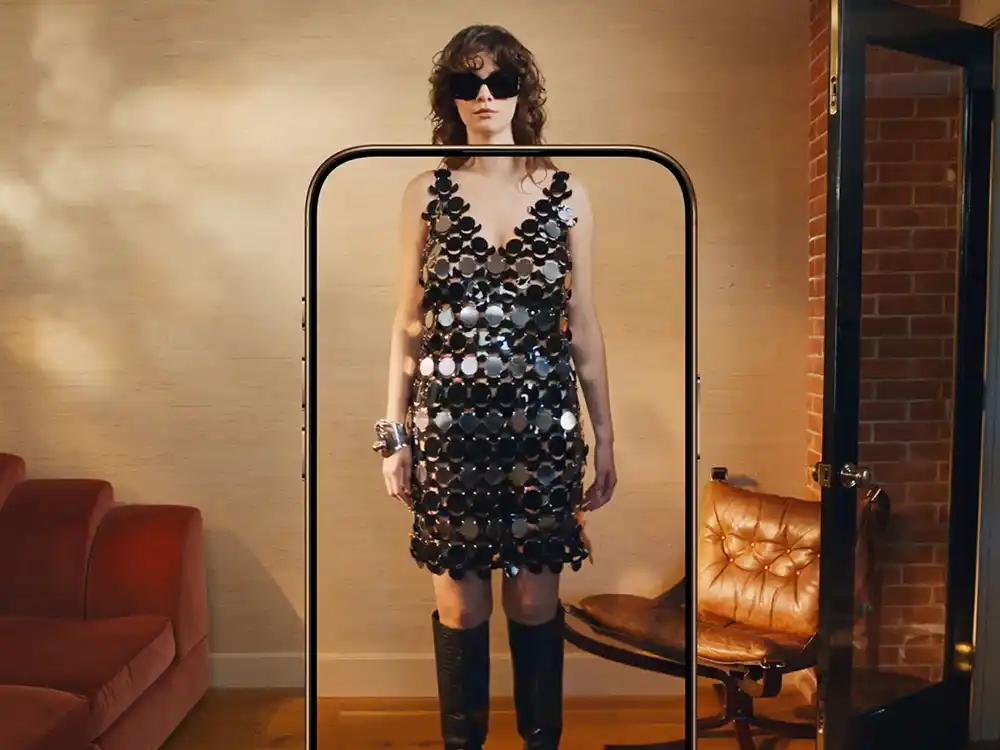 Woman in a sequin disc dress stands inside a giant phone-shaped frame, from Vestiaire Collective's Parlez-vous?