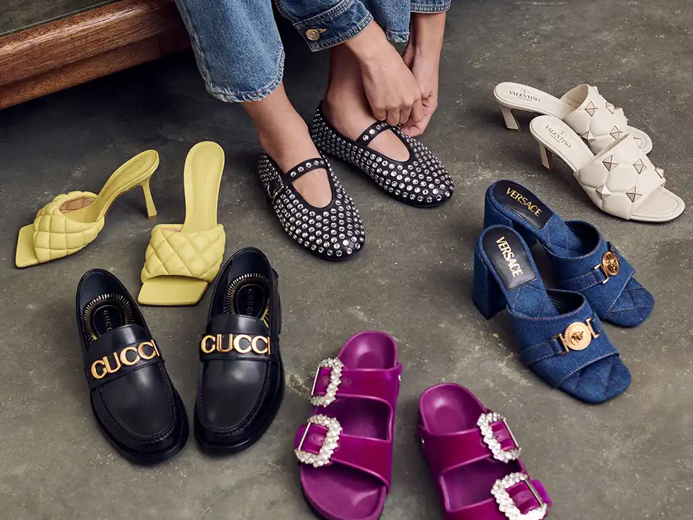 Hands buckle studded flats amid Gucci loafers, Versace mules, and other luxury shoes, from Vestiaire Collective's Parlez-vous?