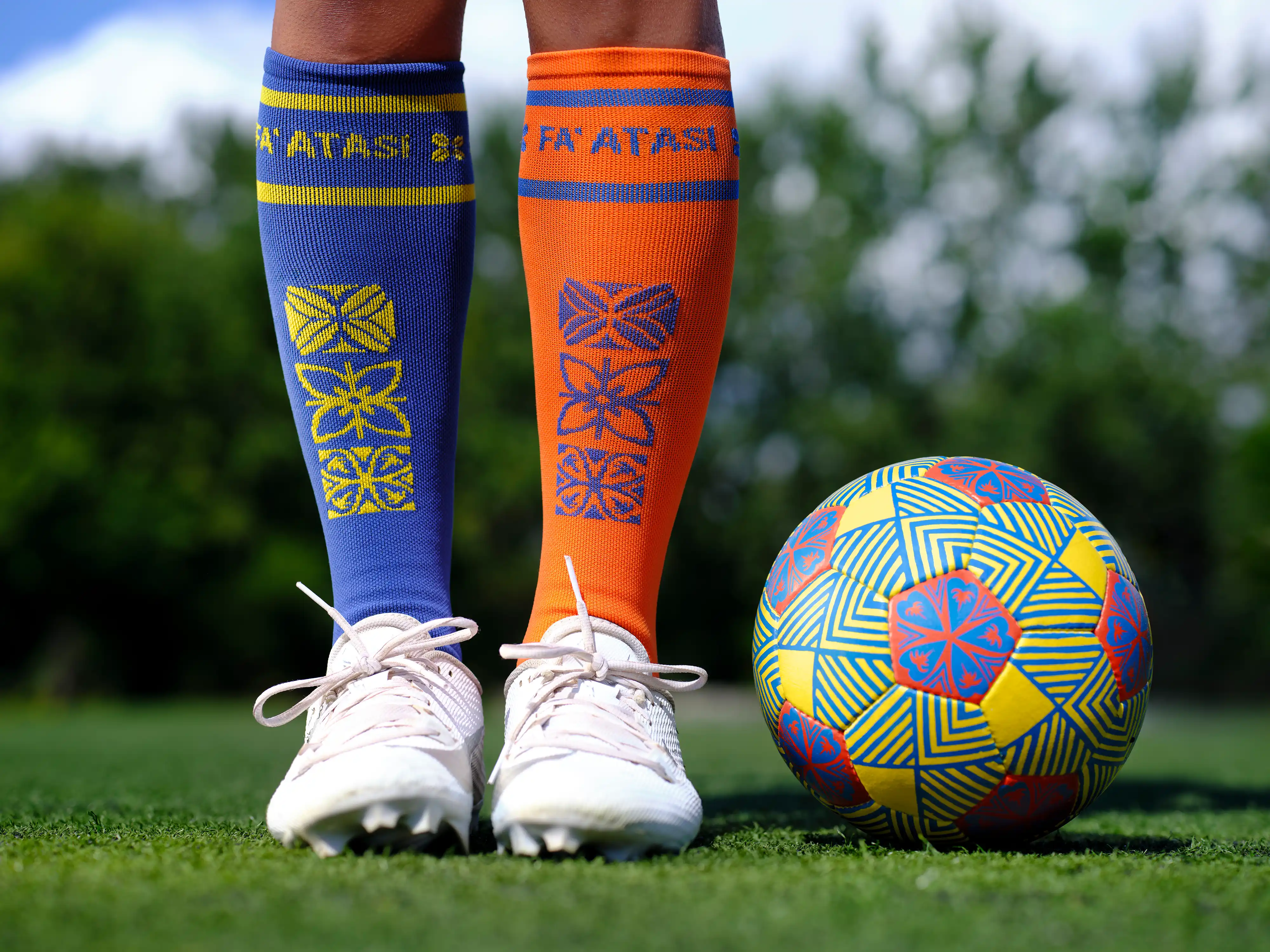 Fa'atasi soccer socks and ball on the field